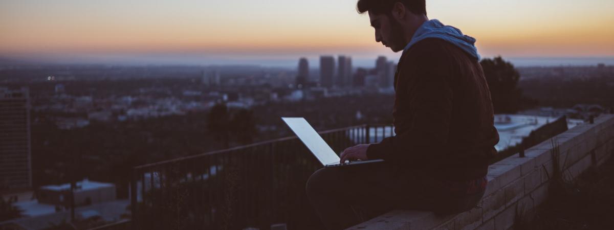 guy on roof on laptop